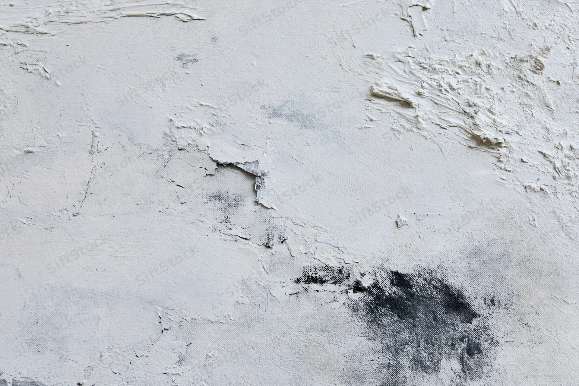 Close-up of abstract painted canvas with textured white and black paint layers showing brushstrokes and cracks