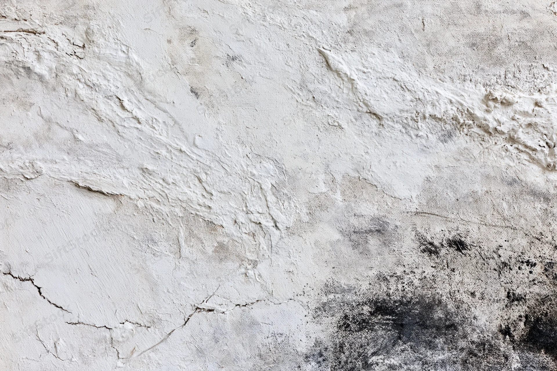 Close-up of abstract painted canvas with textured white and black paint strokes and cracks