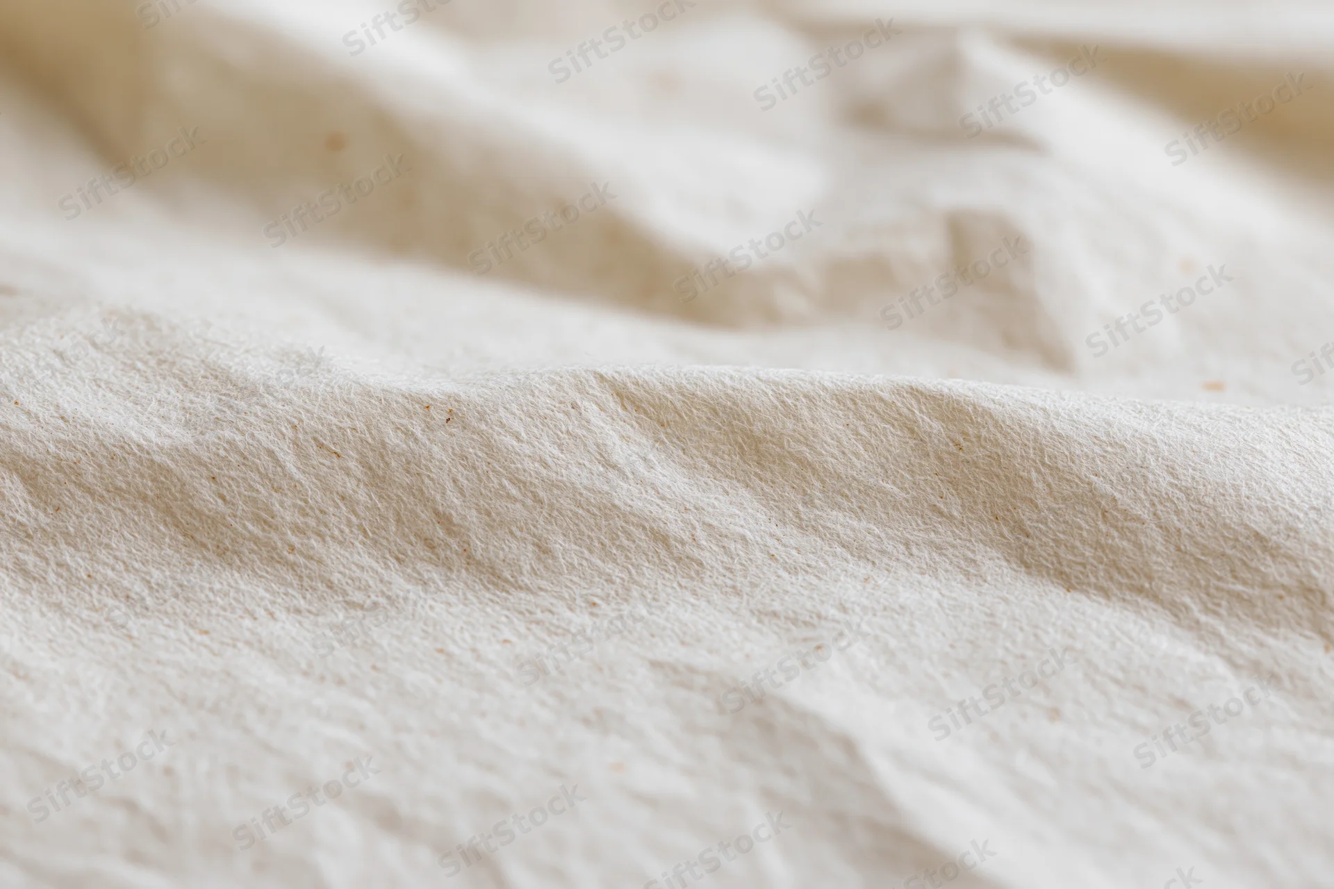 Close-up of crumpled cream kraft paper surface in flat lay arrangement