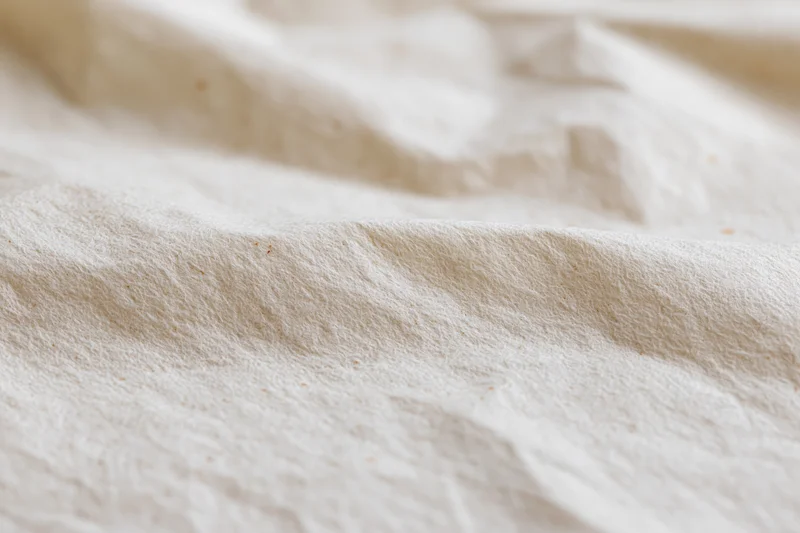 Close-up of crumpled cream kraft paper surface in flat lay arrangement