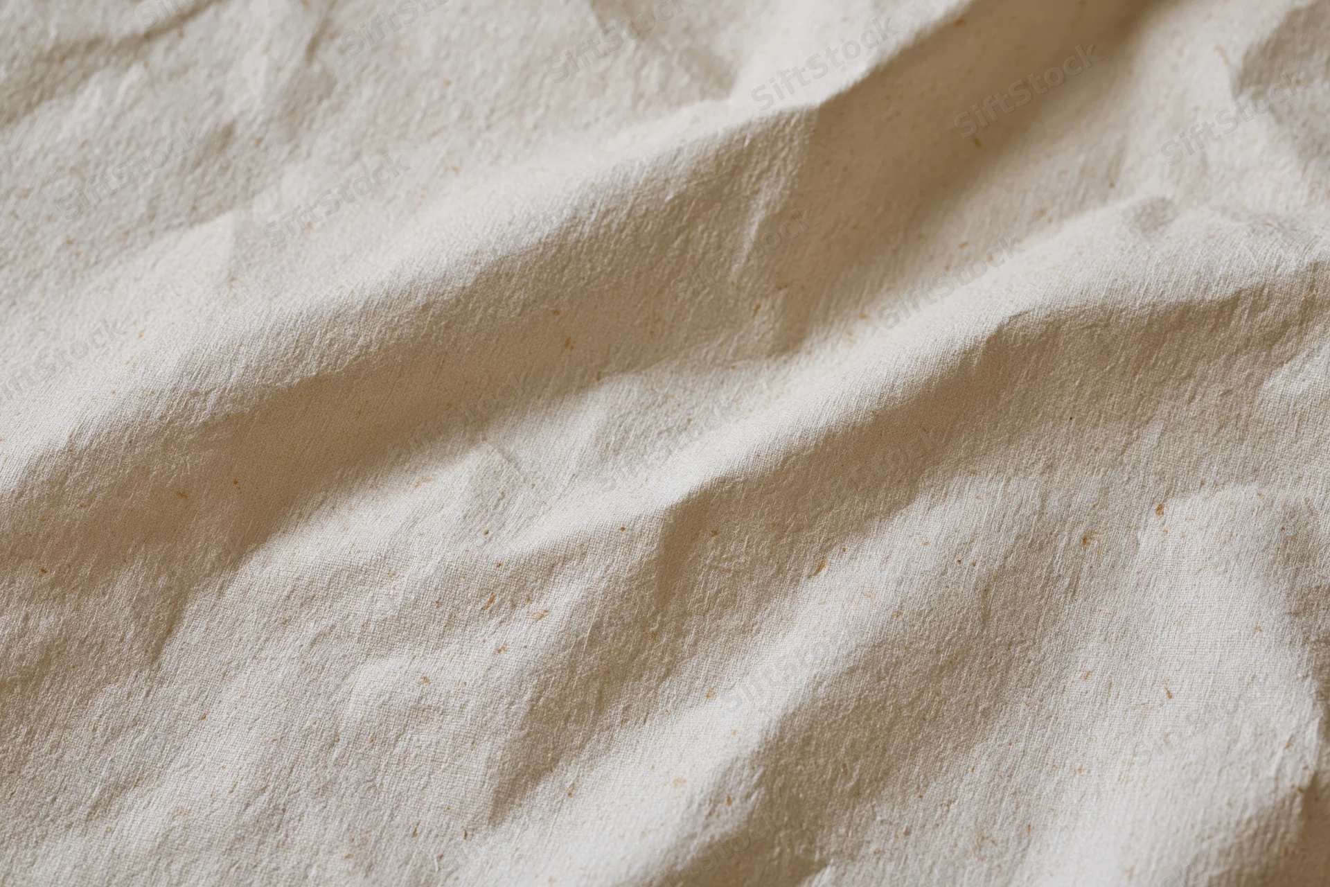 Close-up of crumpled cream kraft paper surface with natural folds and texture