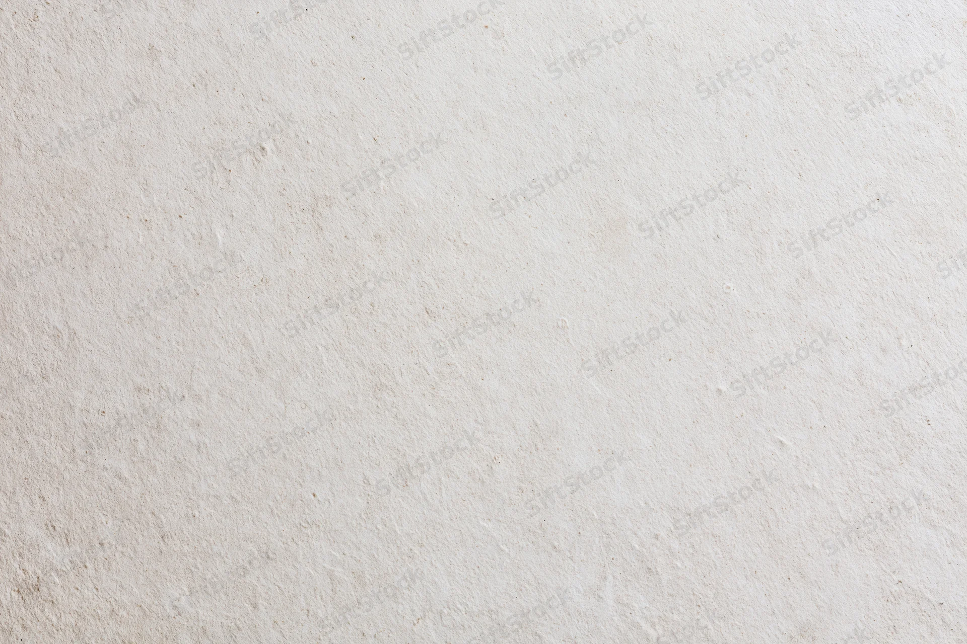 Close-up of a smooth beige plaster wall surface with subtle texture and even lighting