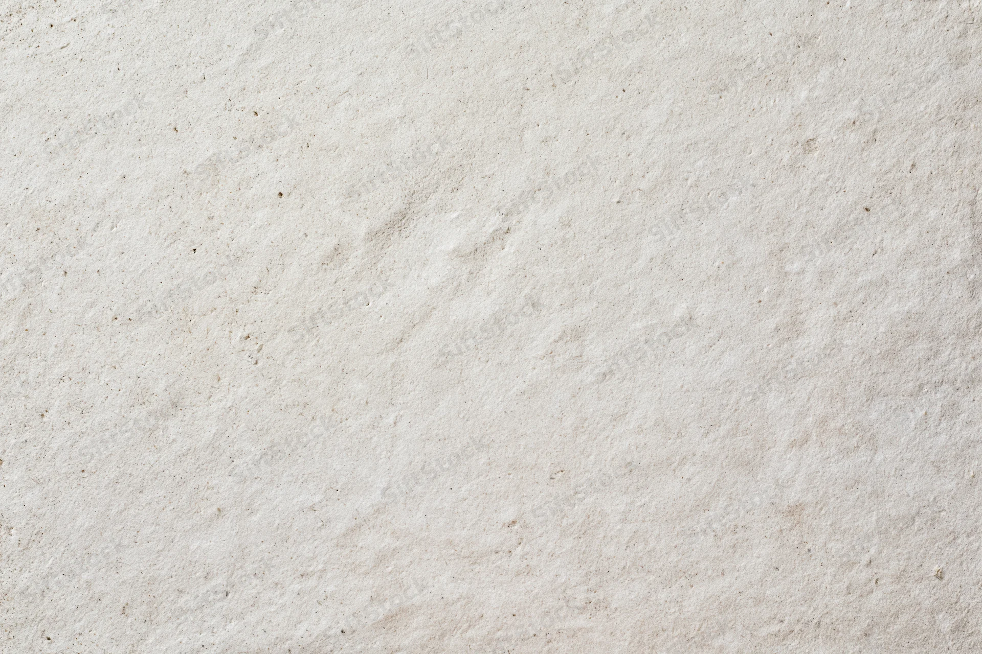 Close-up of a smooth beige plaster wall surface with subtle texture and grainy finish