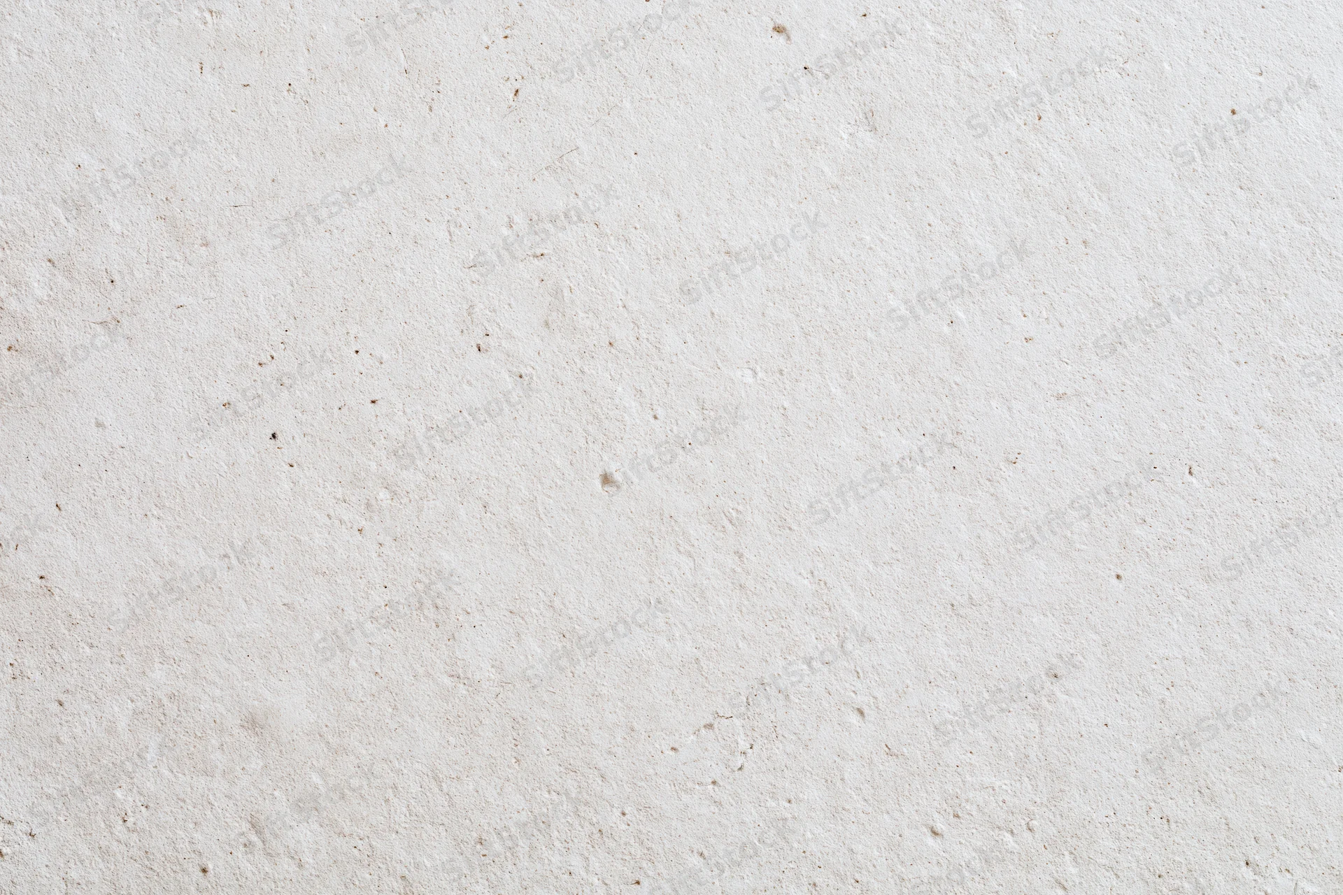 Close-up of a smooth beige plaster wall surface with subtle texture and speckles