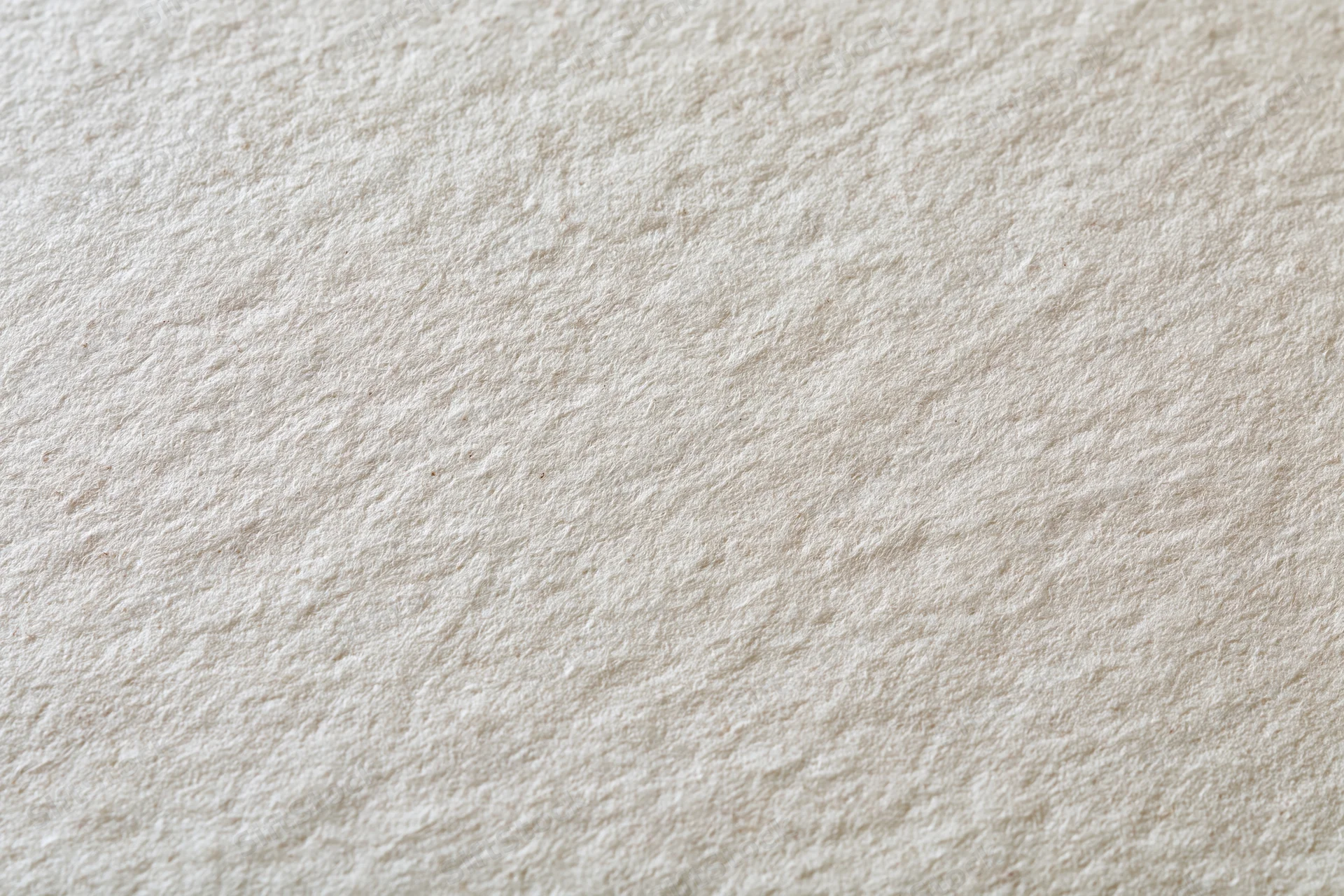 Close-up of aged cream-white paper surface with textured grain filling the frame