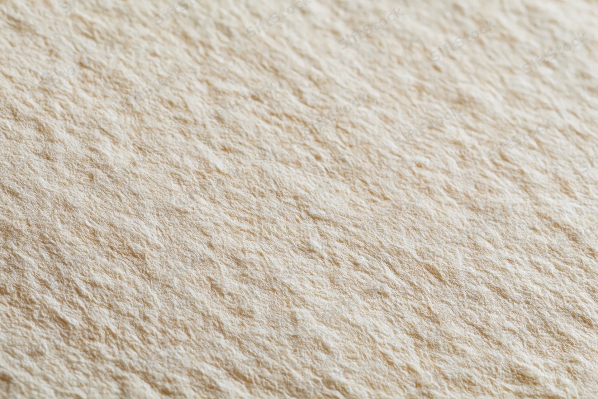 Close-up of aged cream-white paper surface with textured grain filling the frame