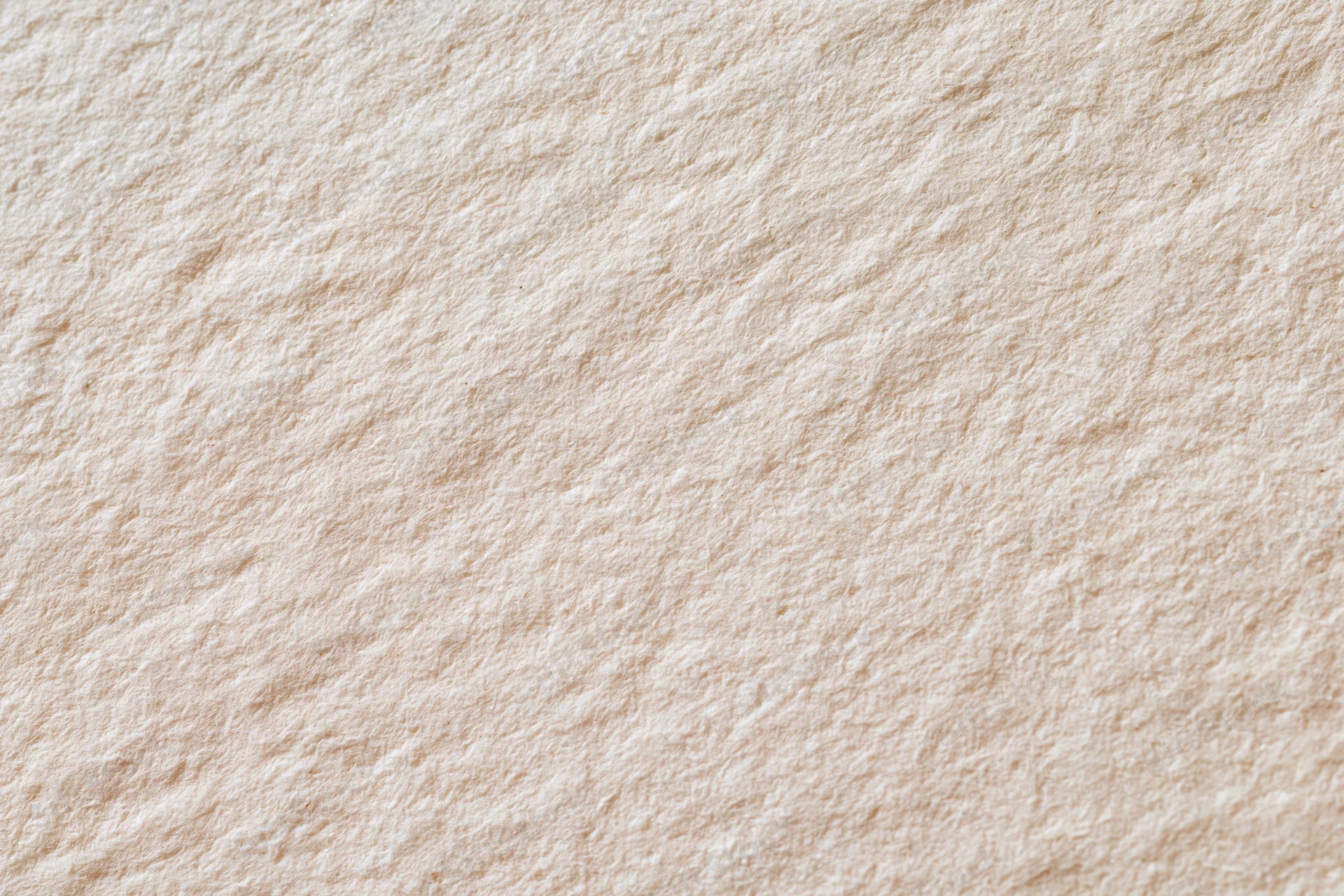 Close-up of aged cream-white paper surface filling the frame