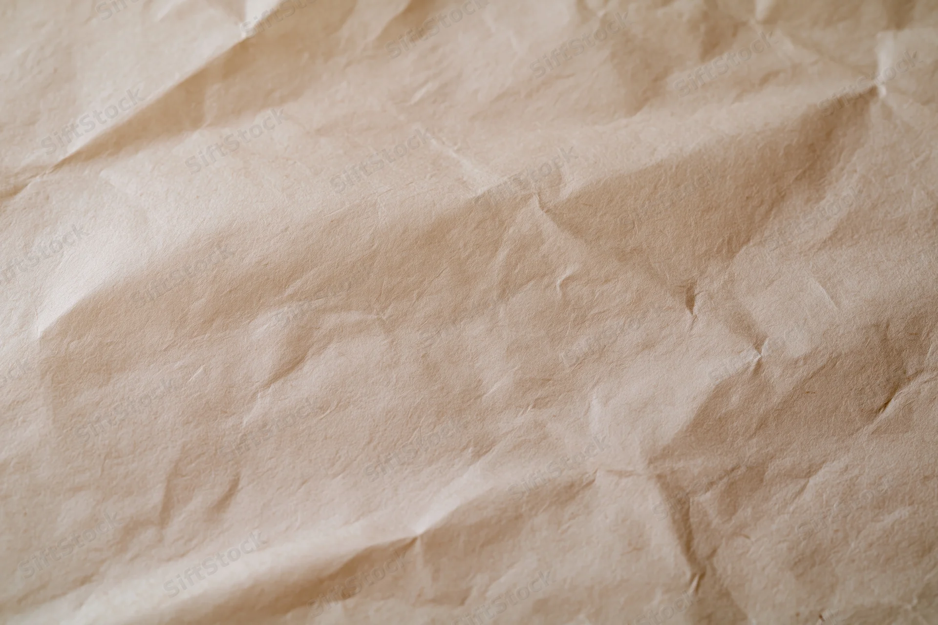 Crumpled cream wrapping paper surface in close-up flat lay