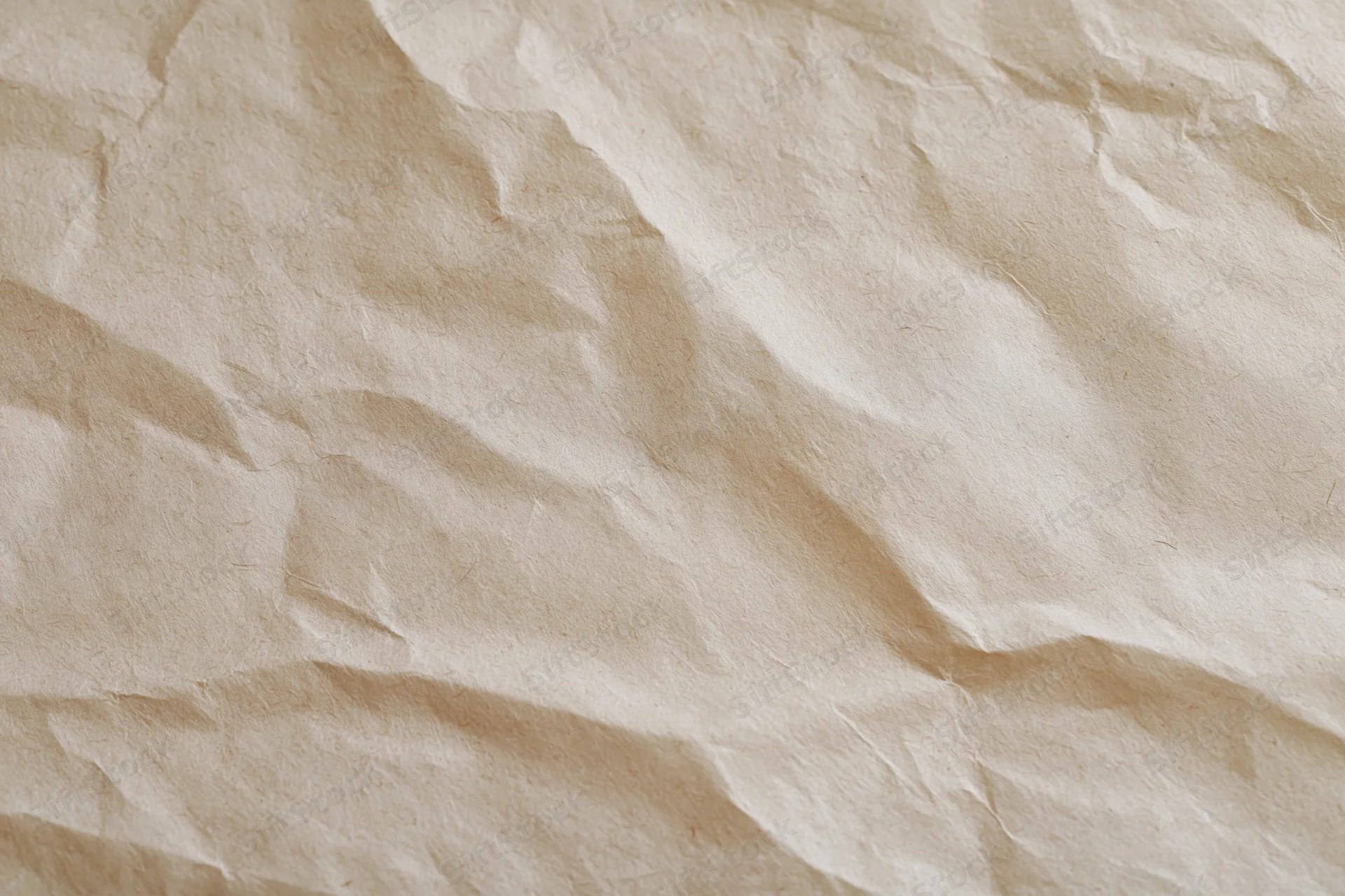 Close-up of crumpled cream wrapping paper with natural texture and folds