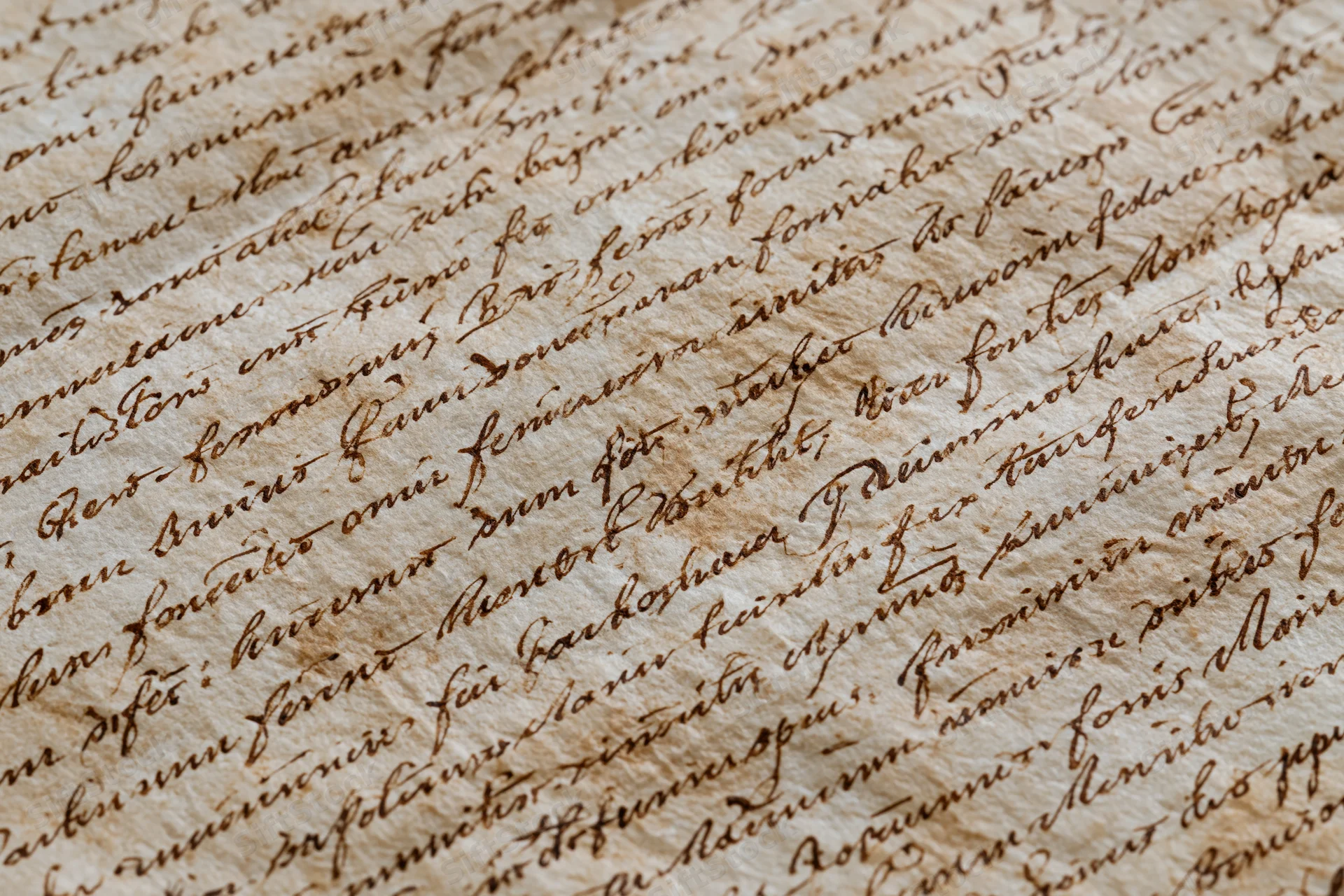 Close-up of aged handwritten manuscript text on parchment paper