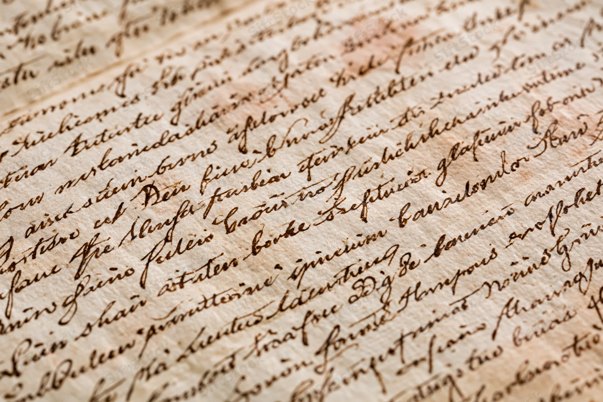 Close-up of aged handwritten manuscript paper with cursive script in German