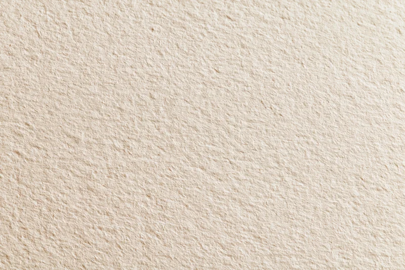 Close-up of blank white watercolor paper with textured surface filling the frame