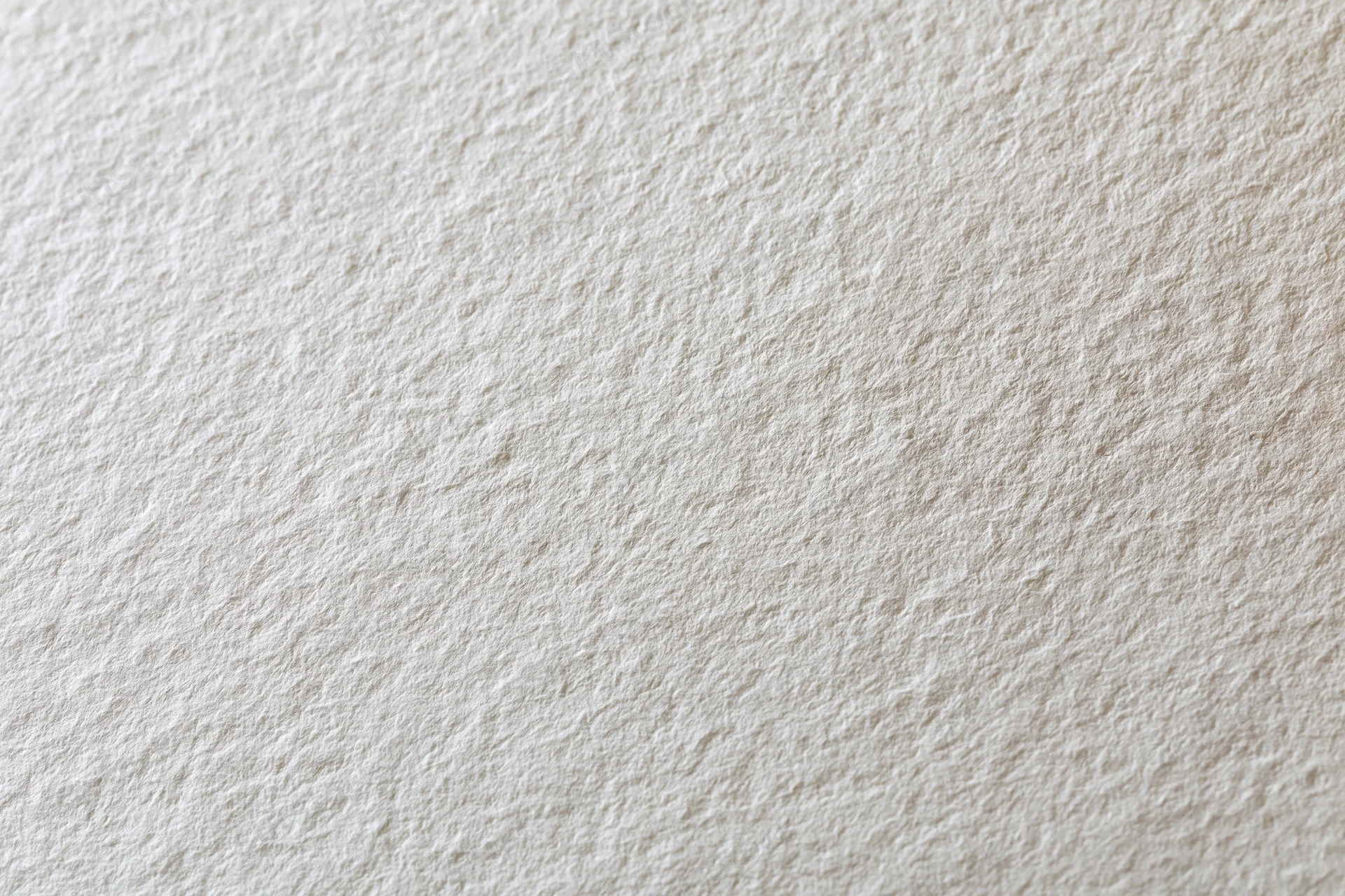 Close-up of blank white watercolor paper with textured surface filling the frame