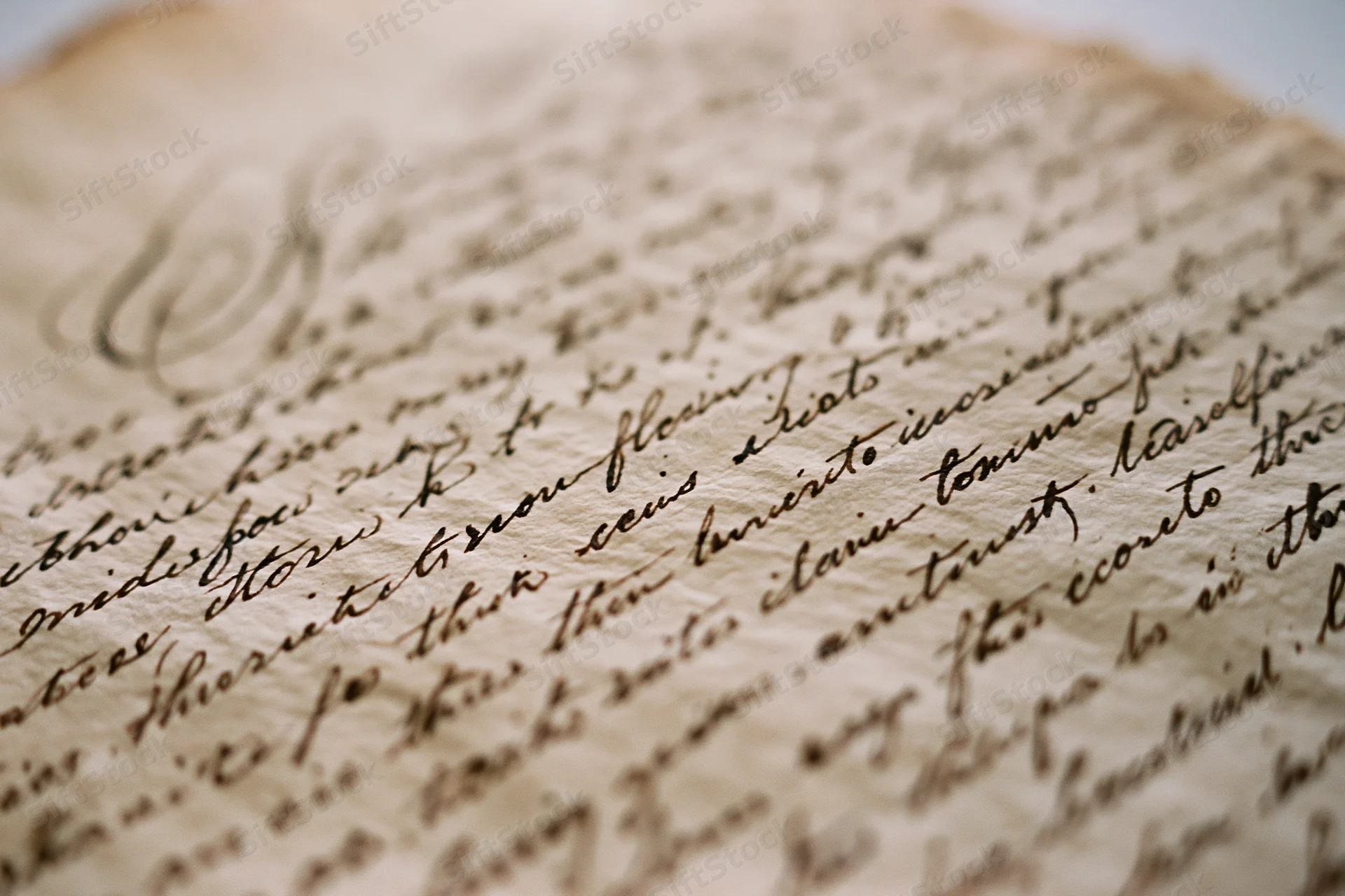 Close-up of aged parchment with 19th-century cursive handwriting