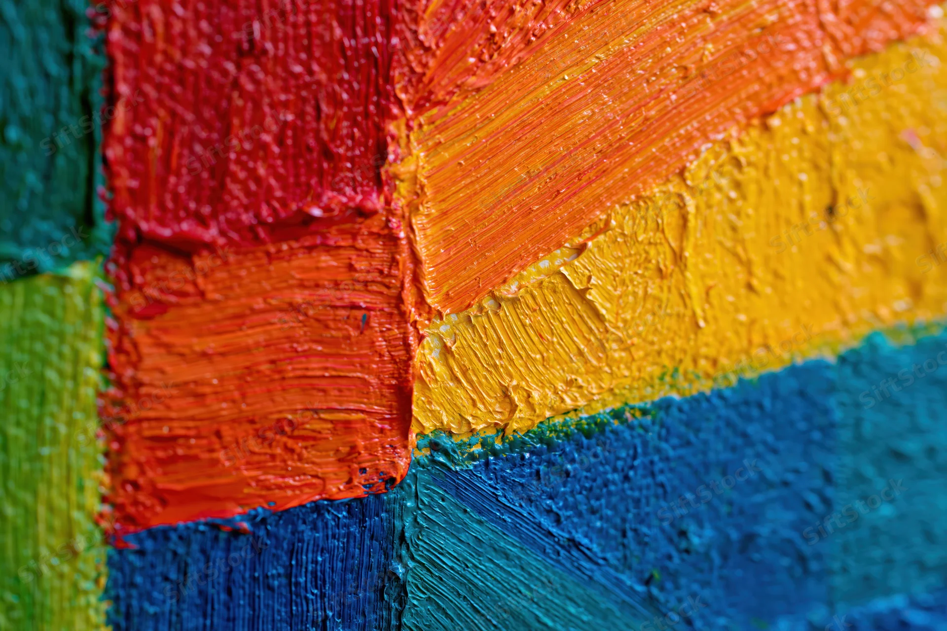 Close-up of thick impasto oil paint strokes on canvas in vibrant colors