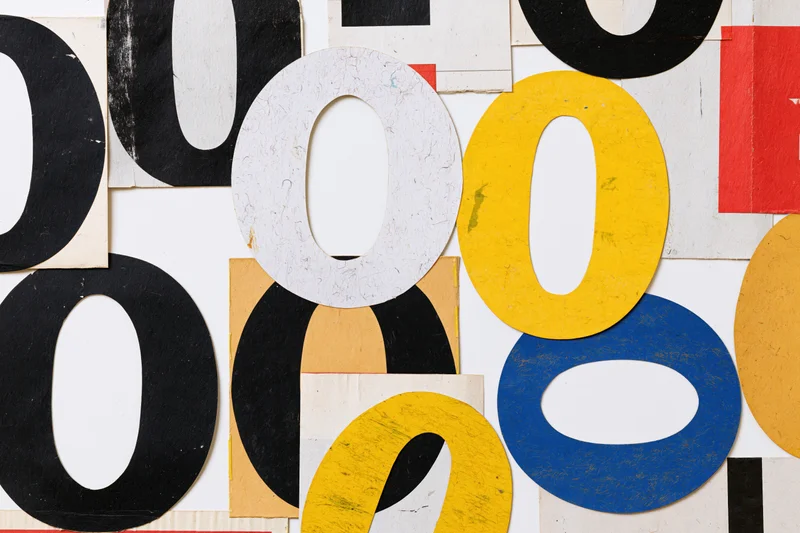 Cut-out letter o and number zero clippings arranged in a colorful collage on white background