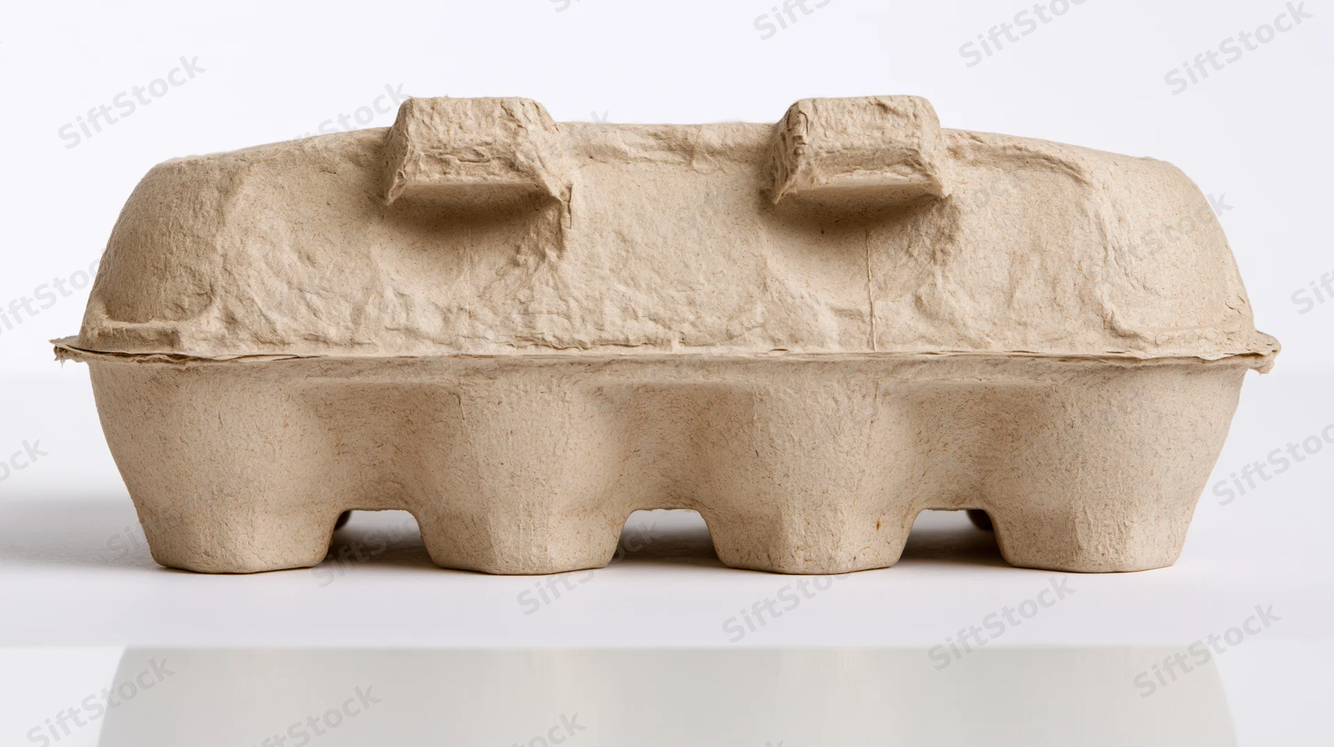 Closed cardboard egg carton on white surface
