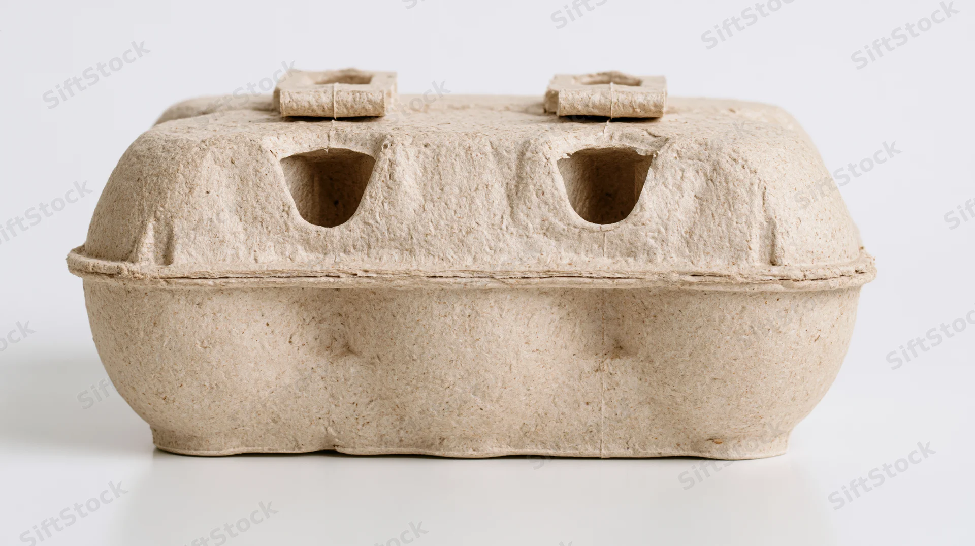 Closed cardboard egg carton on white surface