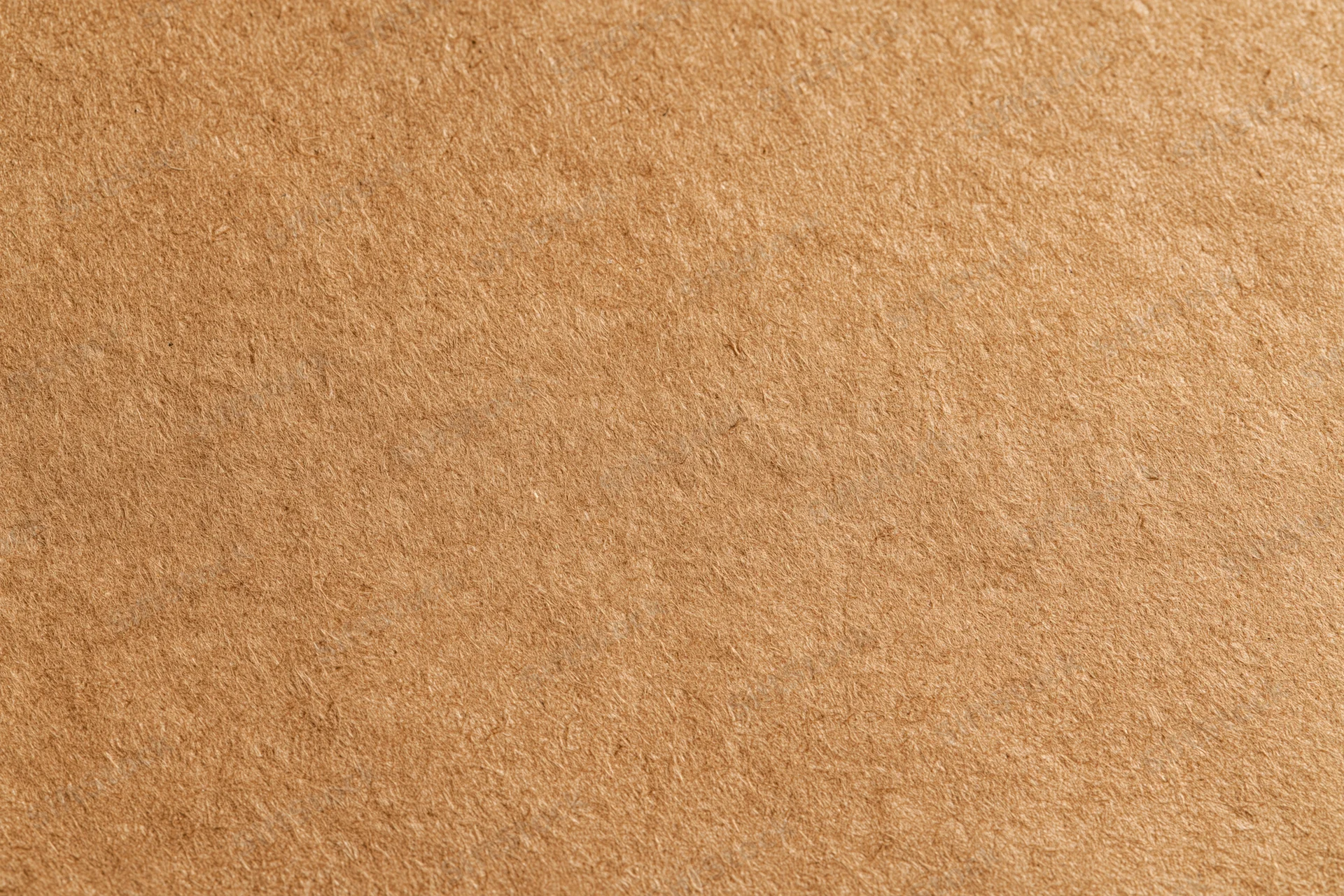 Close-up of a flat sheet of brown recycled kraft cardboard surface