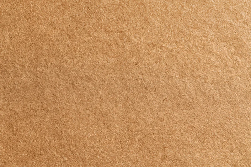 Close-up of a flat sheet of brown recycled kraft cardboard surface