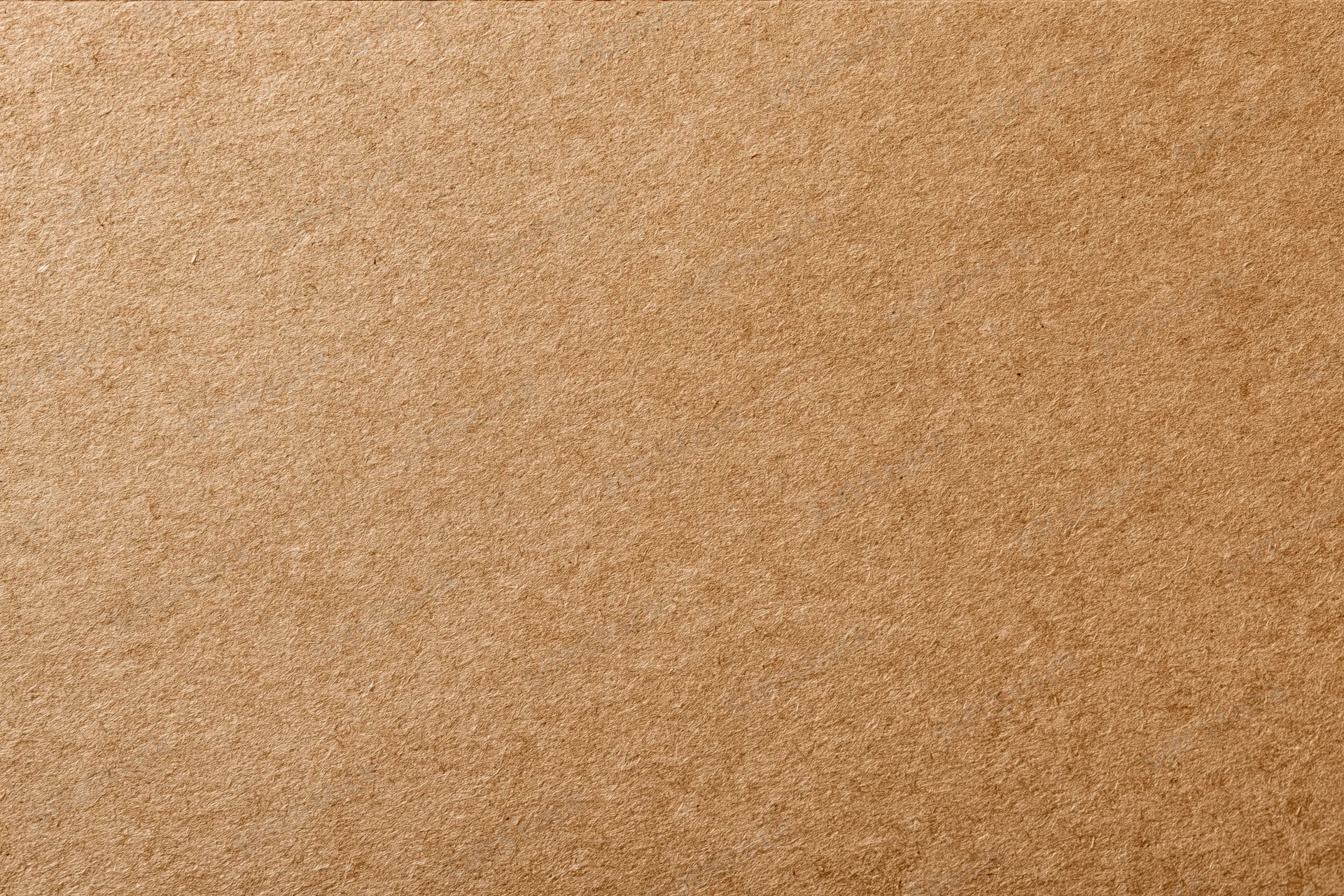 Close-up of a flat sheet of brown kraft recycled cardboard surface
