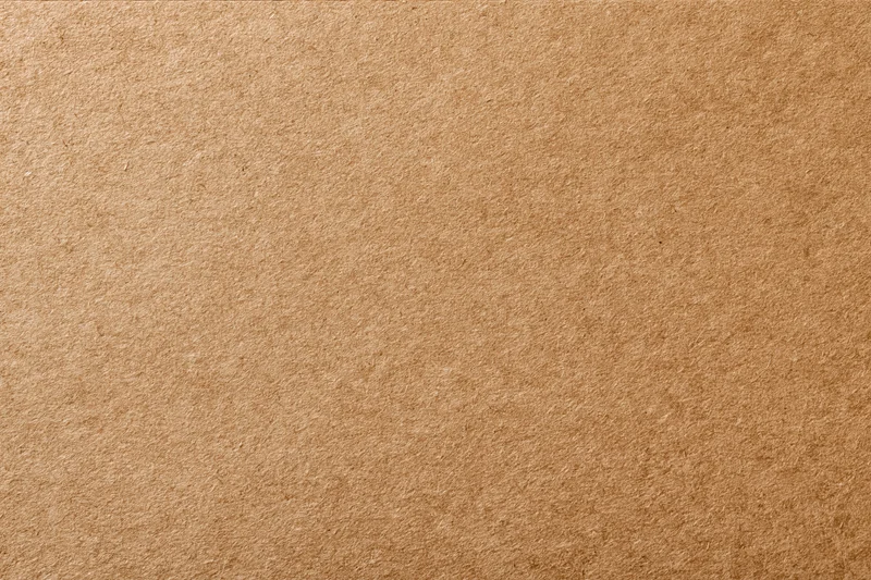 Close-up of a flat sheet of brown kraft recycled cardboard surface
