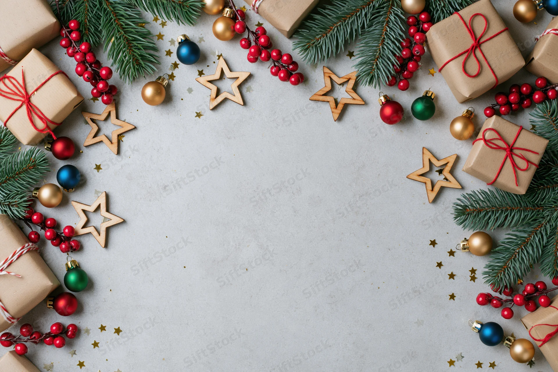 Christmas decorations arranged as a border frame on a flat surface with copyspace in center