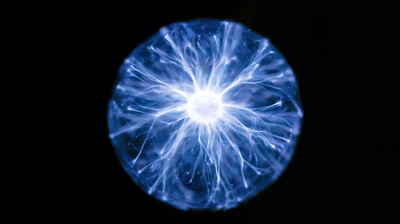 Plasma discharge sphere glowing with electric filaments in a vacuum glass bulb