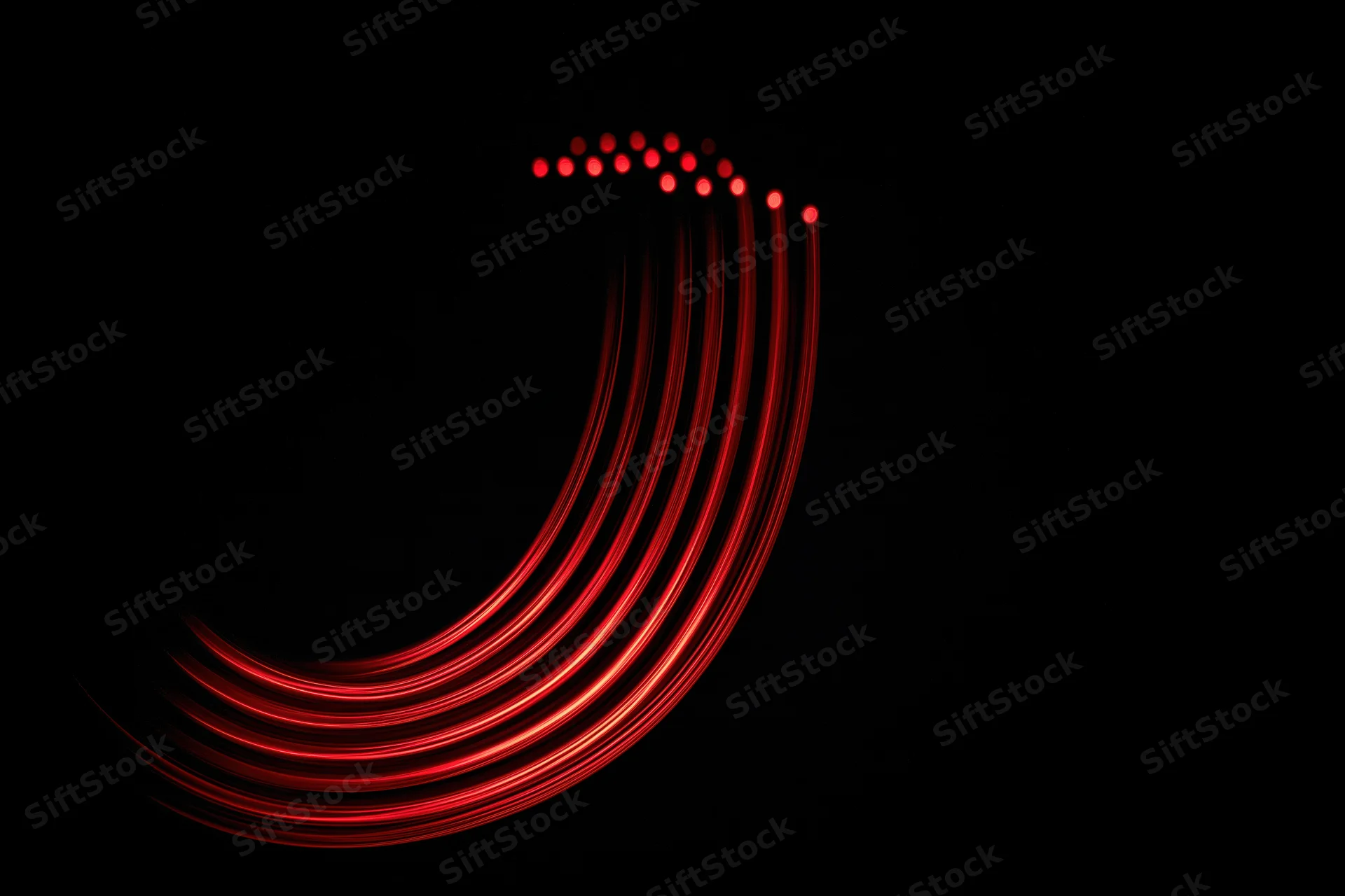 Red light trails forming a lowercase letter j against a black background