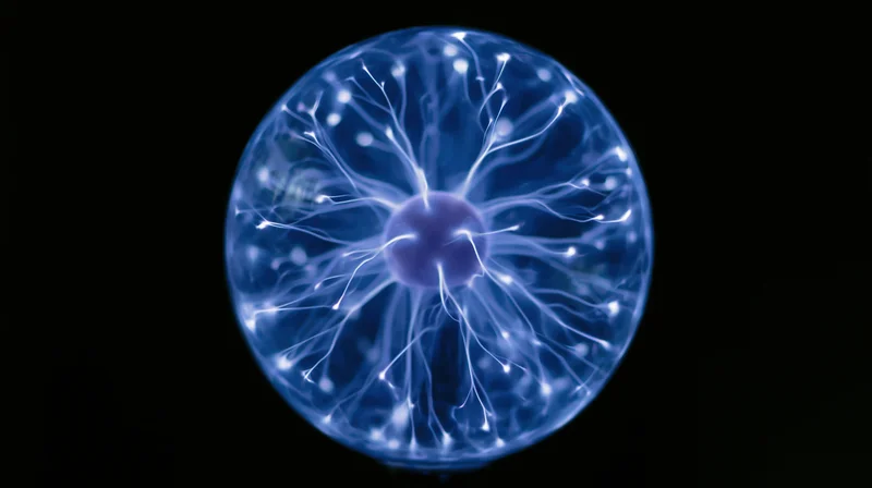 Glowing plasma ball with electric filaments against black background