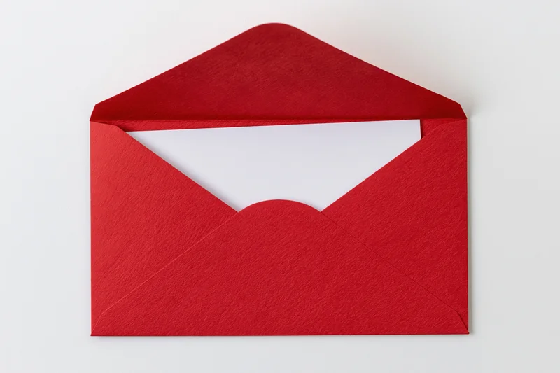 Open red paper envelope with blank white card inside, flat lay on white background