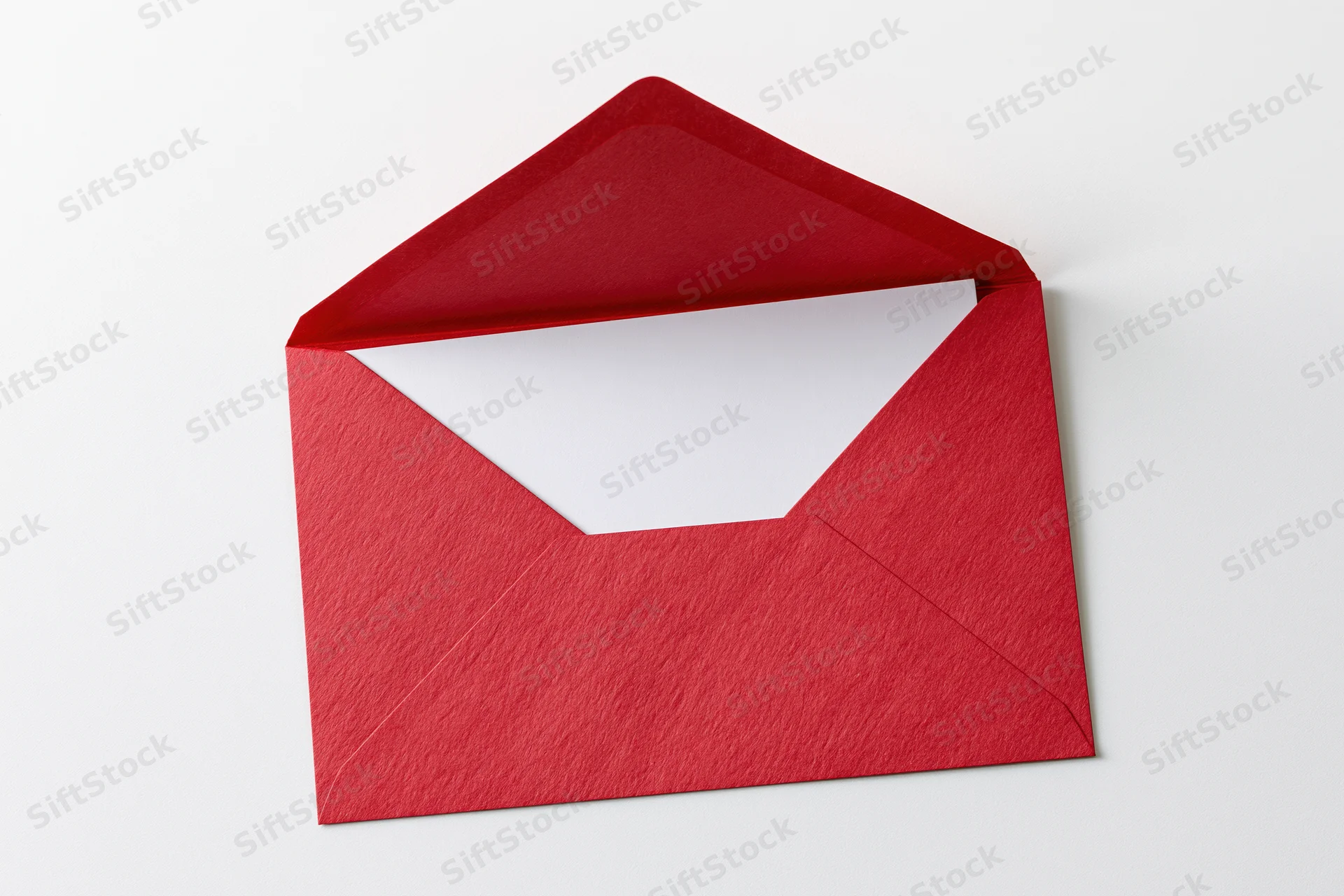Open red paper envelope with blank white card inside on white background