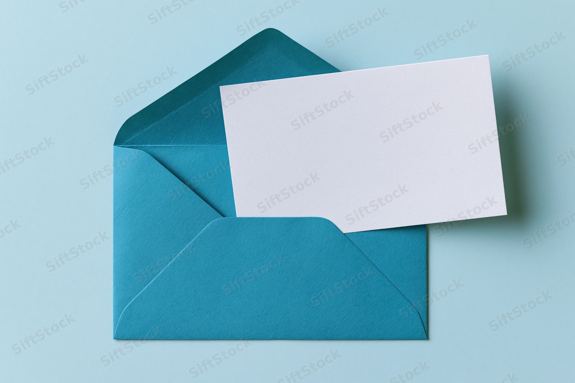 Open teal envelope with blank white card on light blue surface