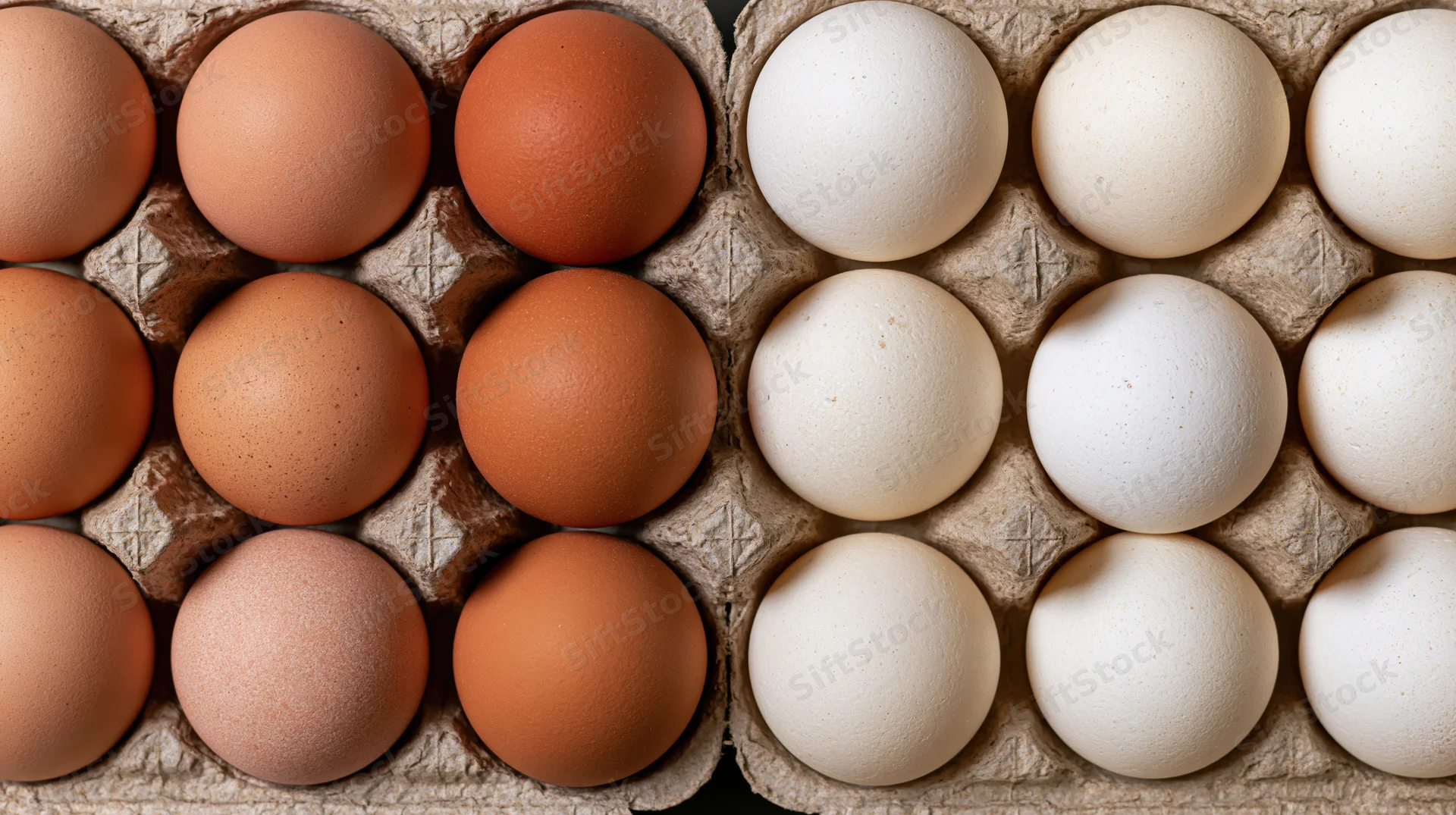 Brown and white eggs arranged in a cardboard carton viewed from above