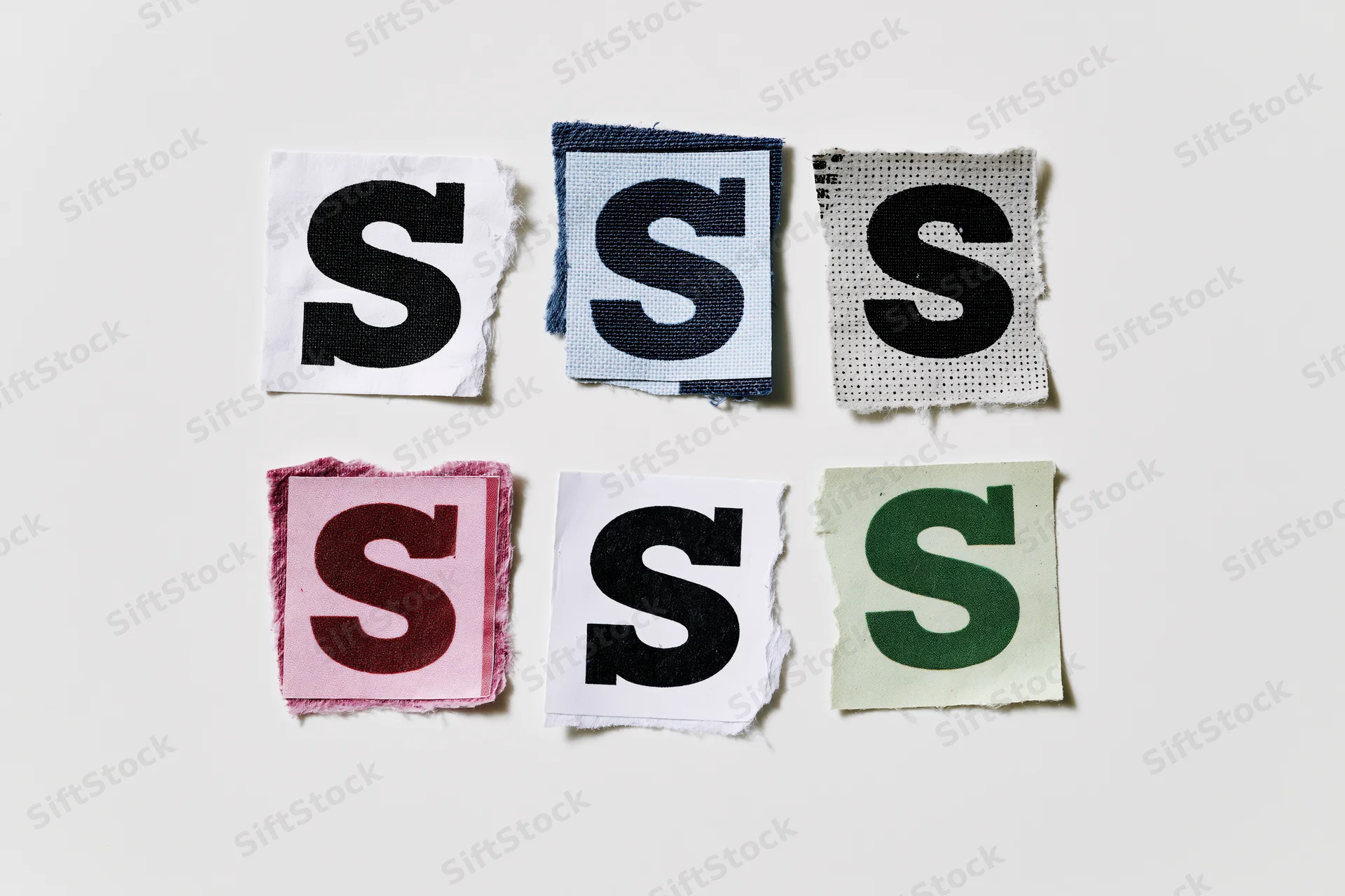Six cut-out letter s clippings arranged in a two-by-three grid on a white surface