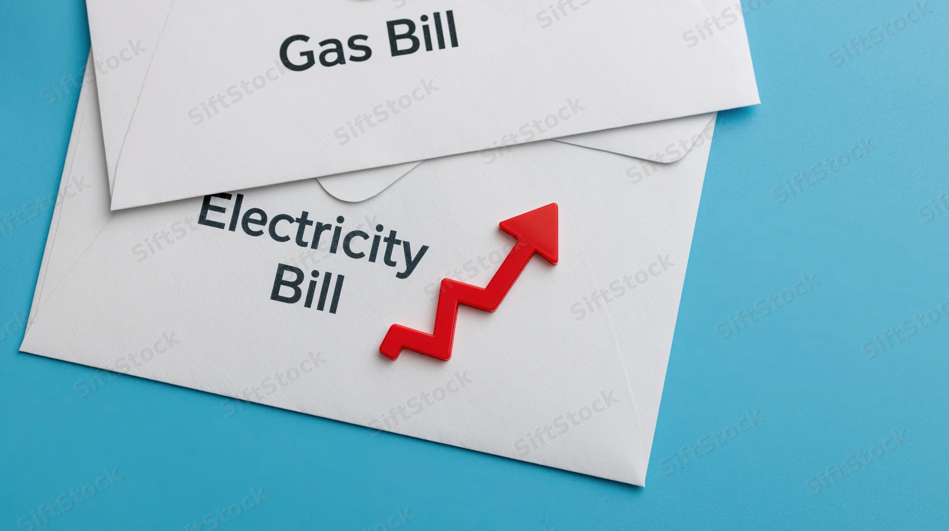 Two white utility bill envelopes labeled gas bill and electricity bill with a red upward arrow on a blue background