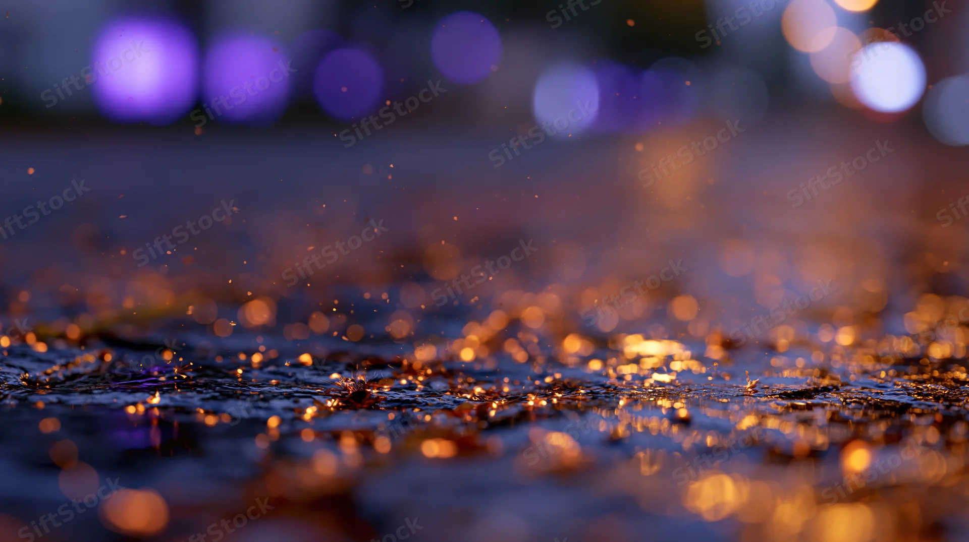 Glowing embers scattered across wet cobblestone pavement at night with blurred city lights in background