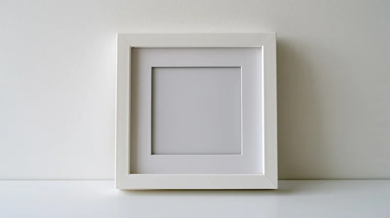 White frame with blank mat lying flat on a white surface