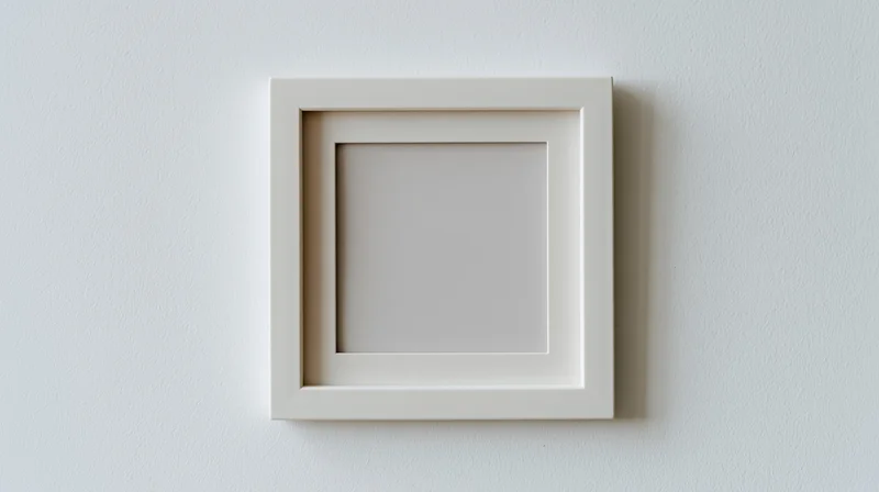 White square frame hanging on a plain wall with empty center for display