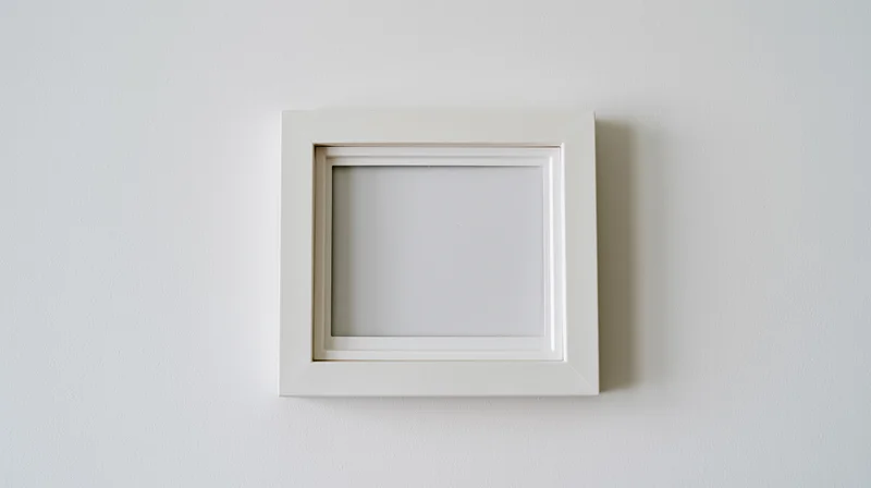 White blank polaroid frame hanging on a plain wall