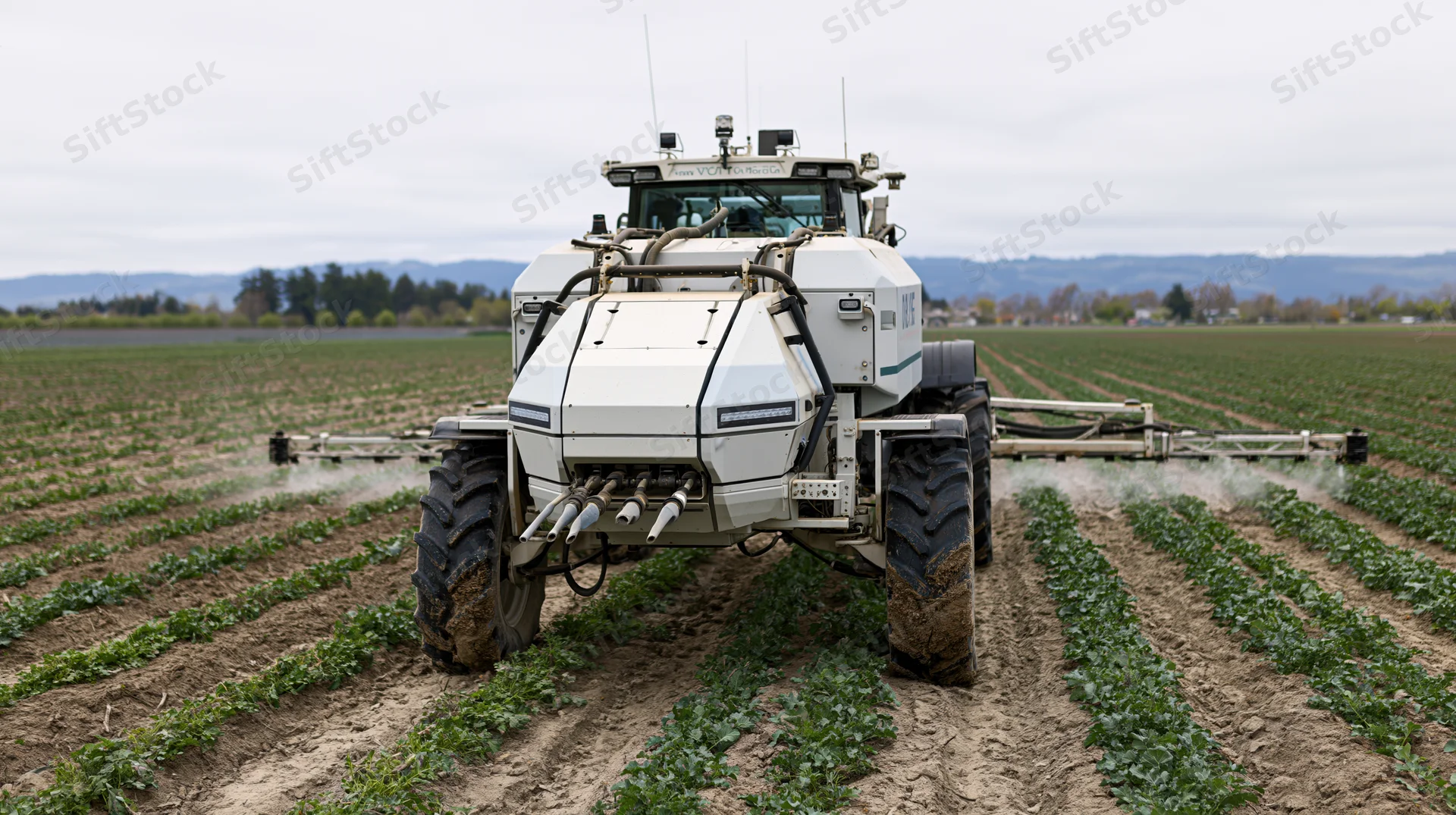 Autonomous tractor spraying crops in a field