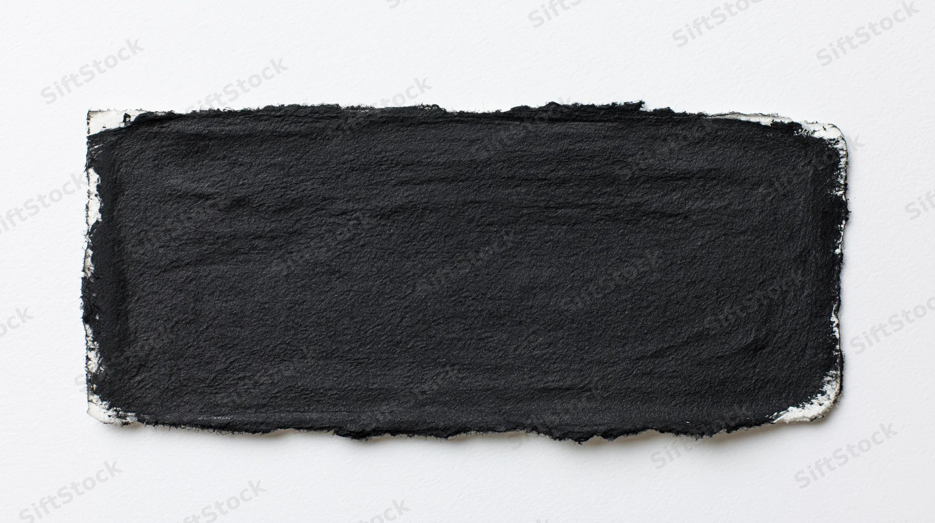 Black ink wash painted on white paper with textured edges and copyspace