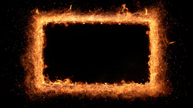 Rectangular frame of burning fire and glowing embers on black background with copyspace