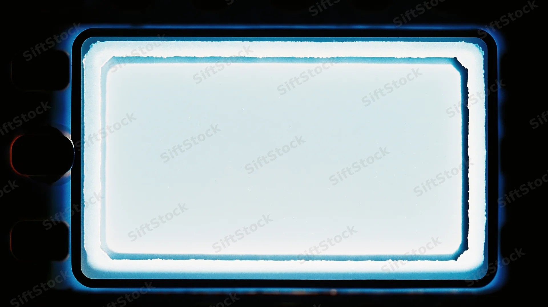 Blank 35mm film frame illuminated from behind with blue glow, dark background