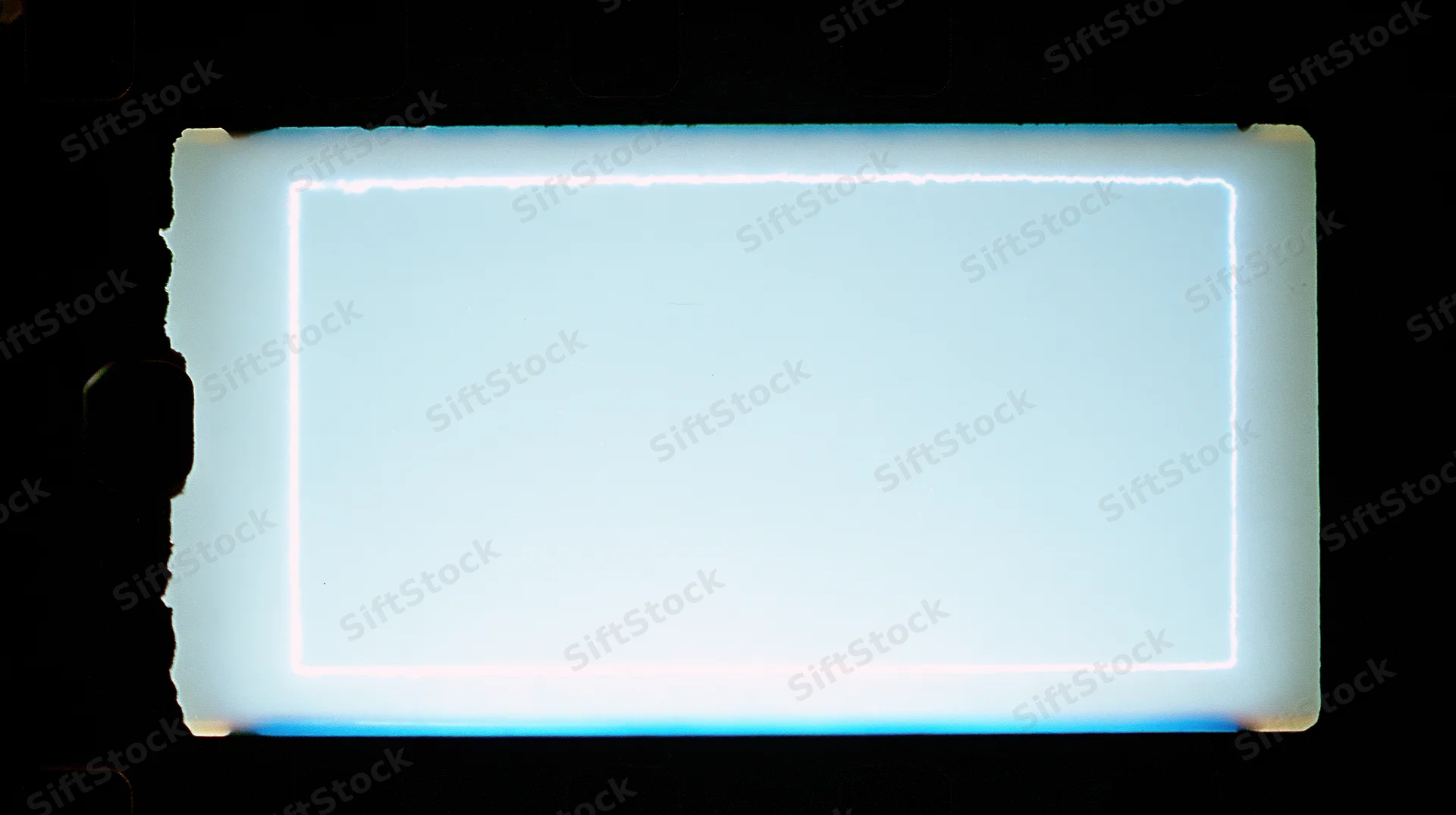Blank 35mm film frame illuminated against dark background