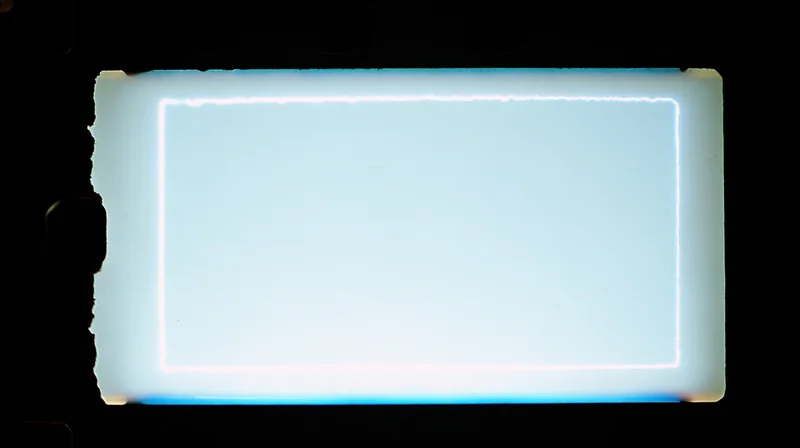 Blank 35mm film frame illuminated against dark background