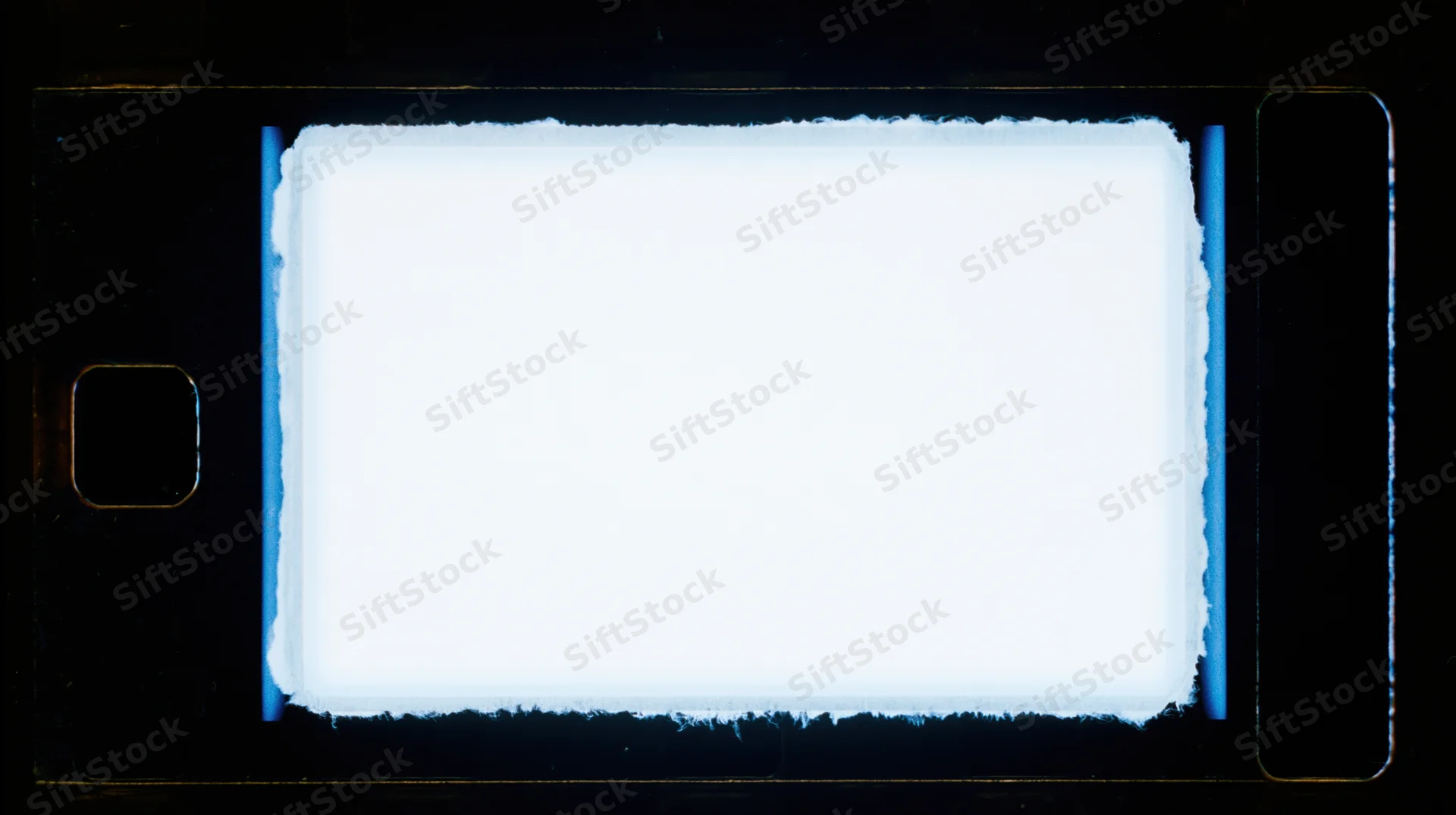 Blank 35mm film frame illuminated against dark background with blue edges and sprocket holes visible