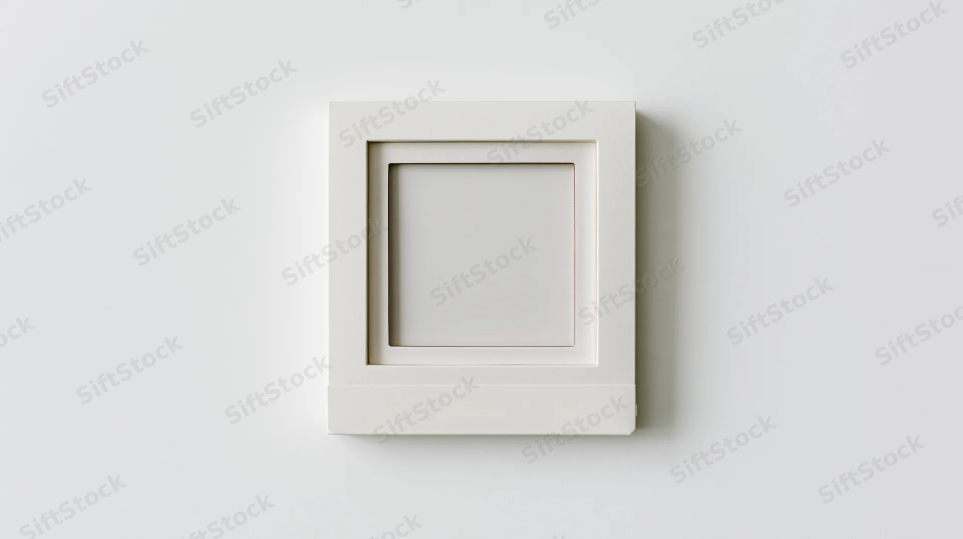 Blank polaroid photo frame lying flat on white surface