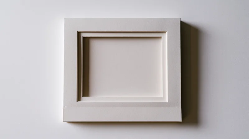 Blank polaroid photo frame lying flat on white surface