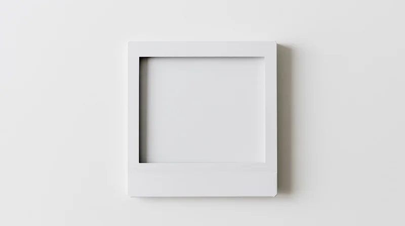 Blank white polaroid frame lying flat on a plain surface
